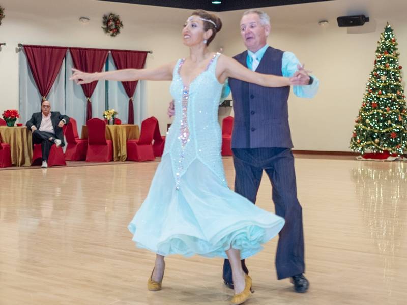 Jeanette dancing with student American Foxtrot at Showcase